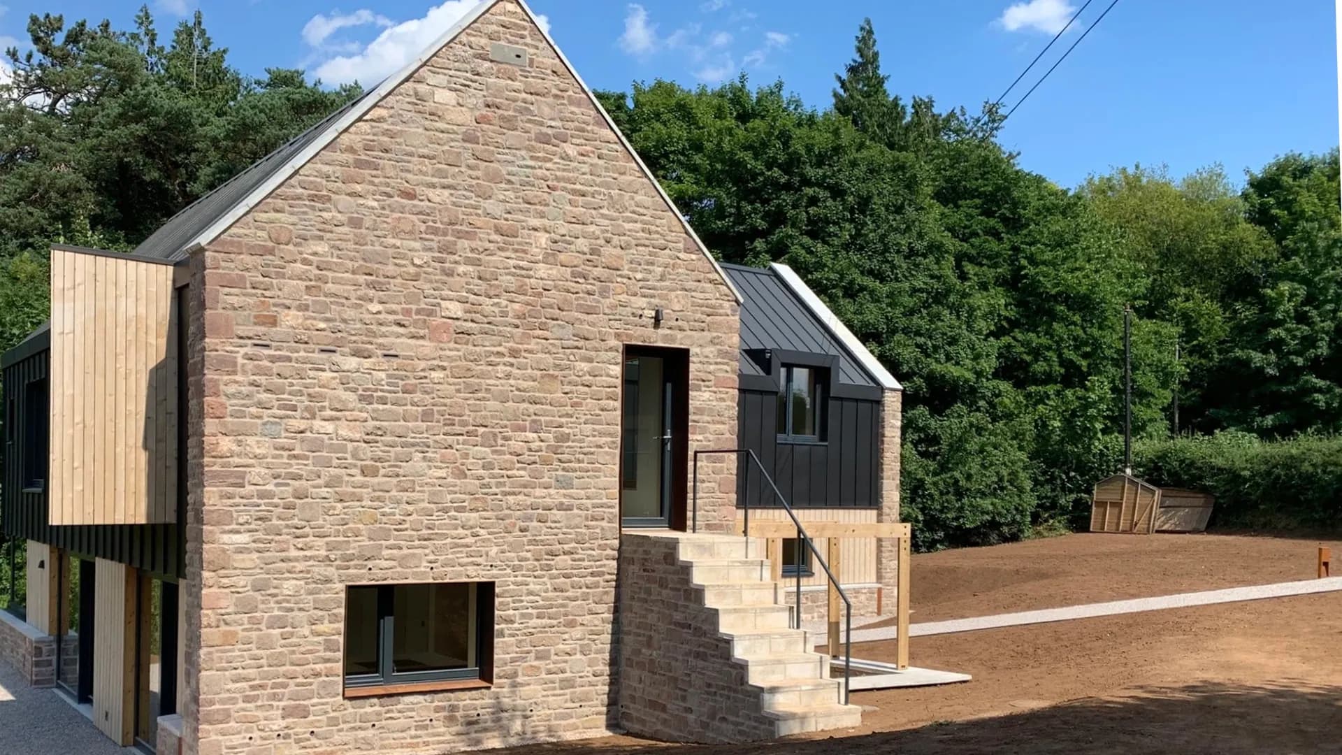 The barn-style home with its stone gable, timber cladding and stone steps, Monmouthshire