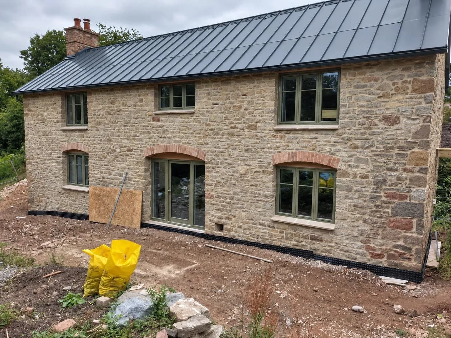The restored Georgian house in lime pointed stone, with its new windows, Forest of Dean