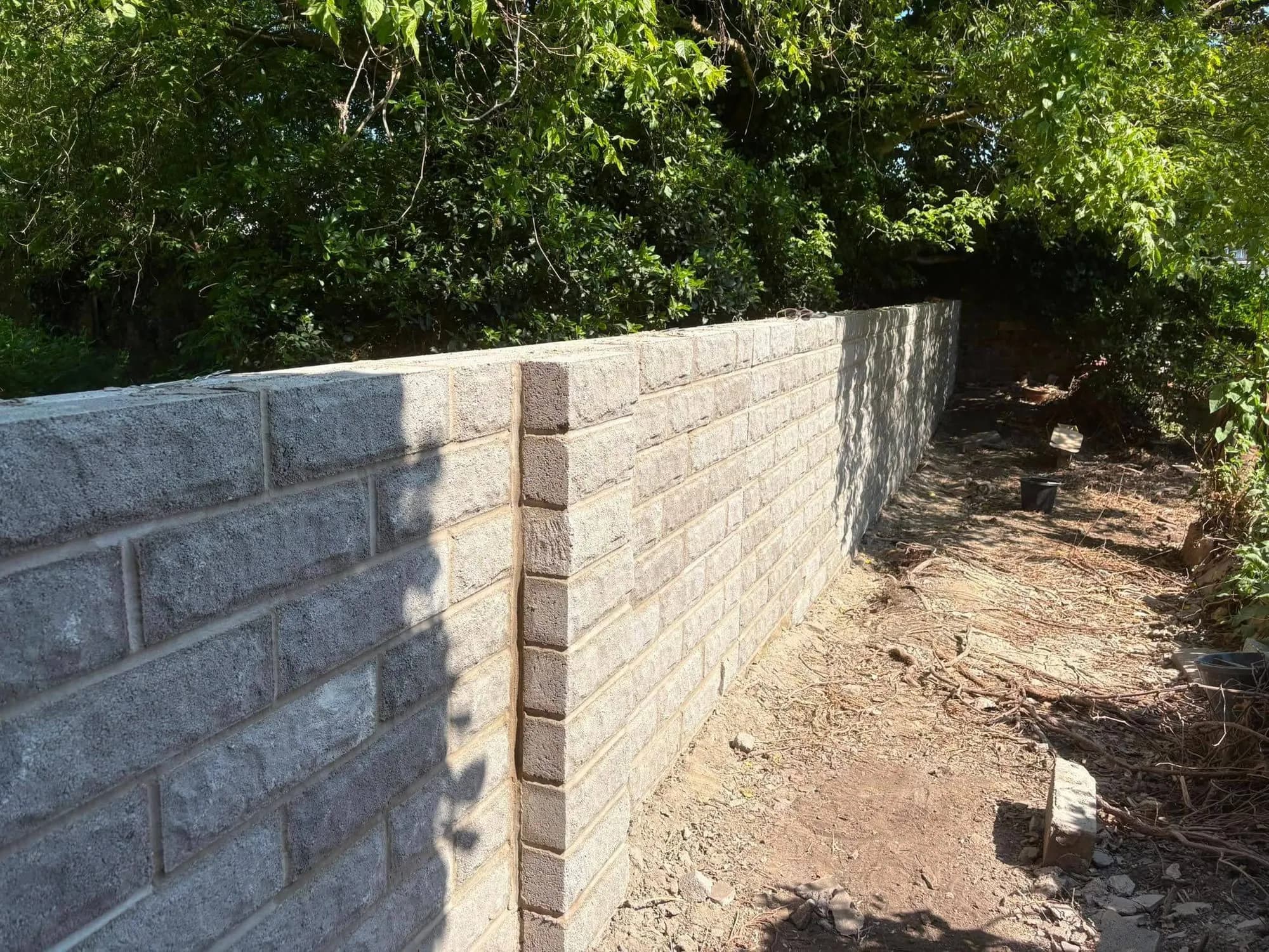 The rebuilt wall in rock-faced blocks, Monmouth