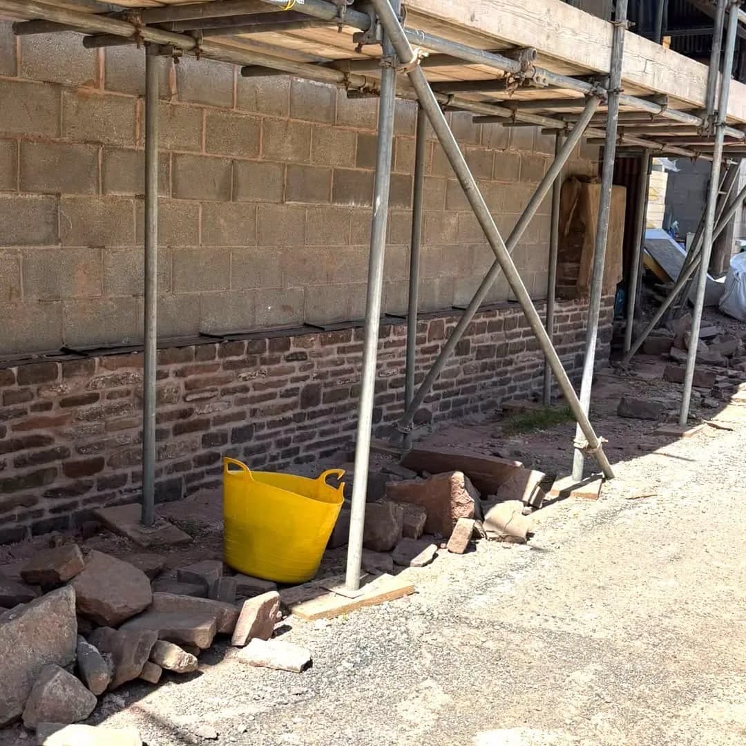 Red stone walling going up in lime under the scaffold, Monmouthshire