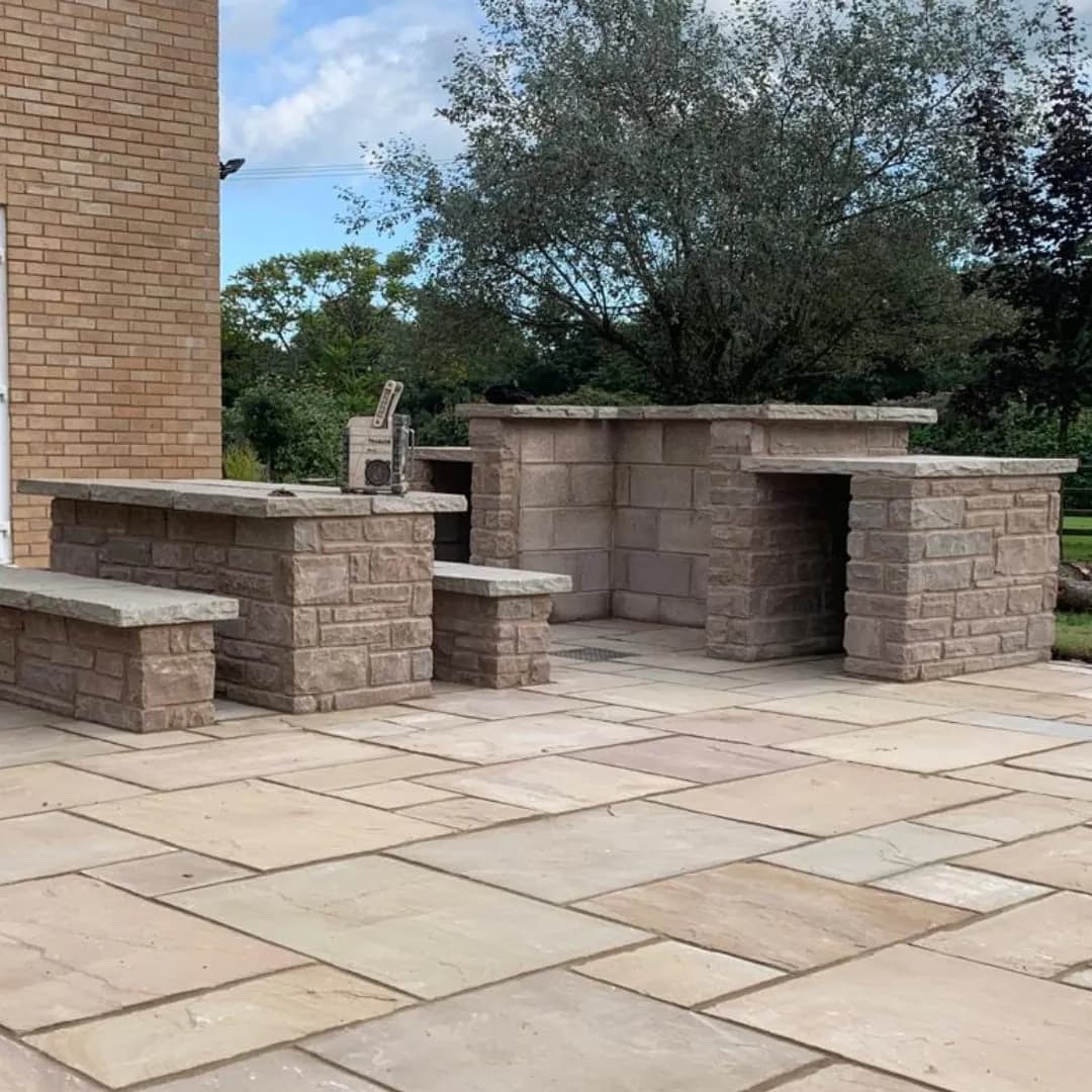 The finished outdoor kitchen and benches on the sandstone patio, Monmouthshire